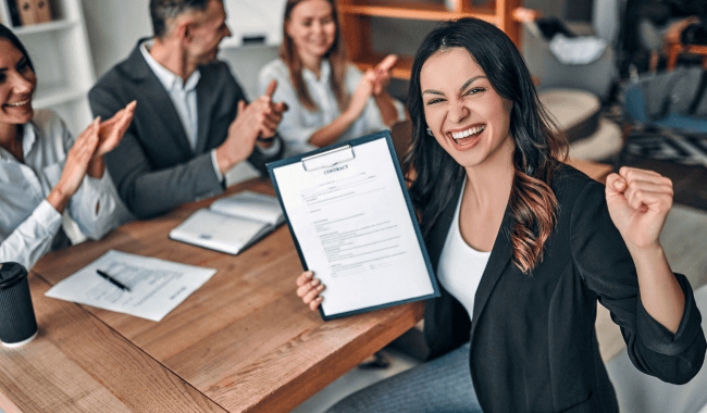 A woman presenting a document to colleagues during a walk-in interview.